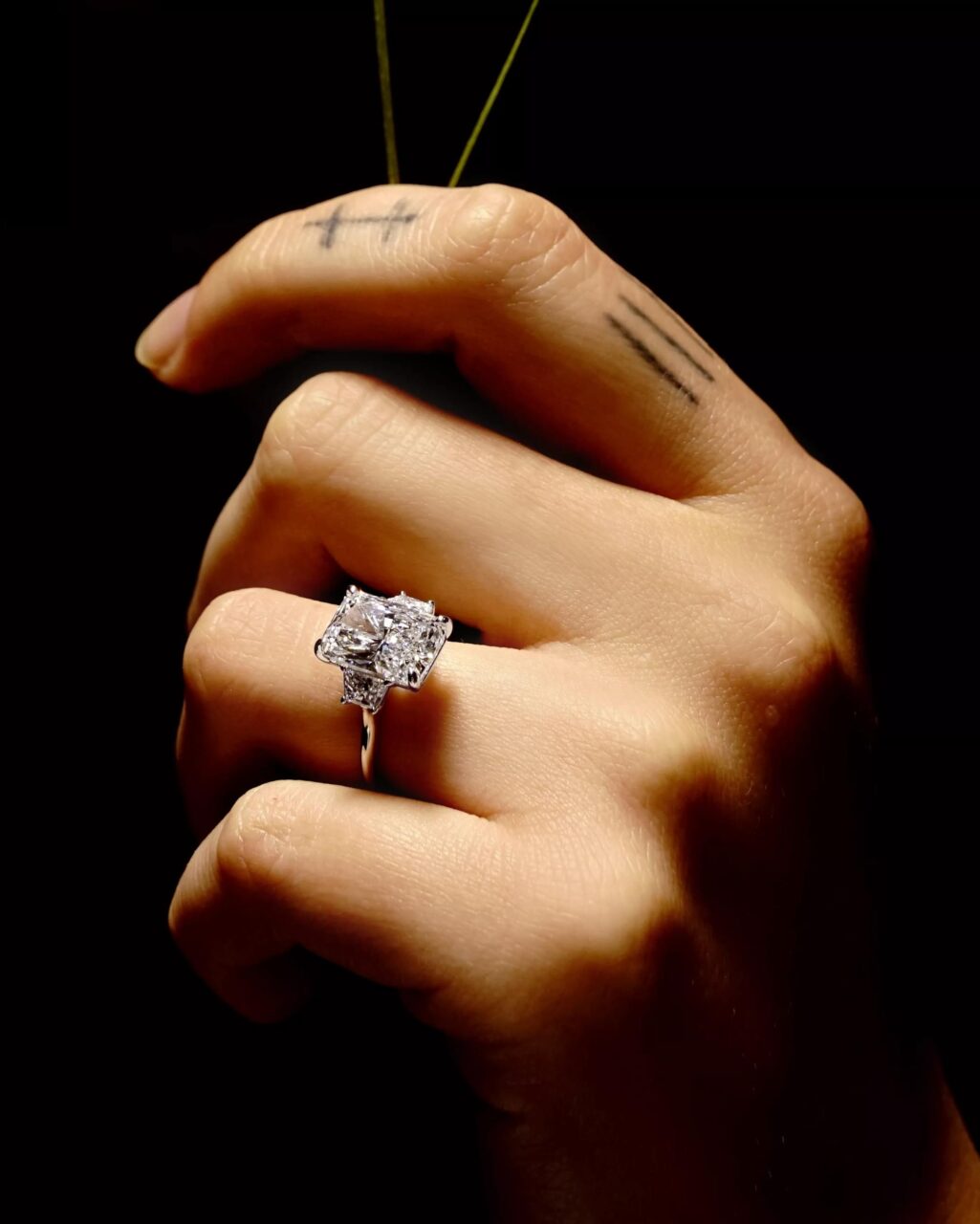 A radiant cut three stone diamond engagement ring 