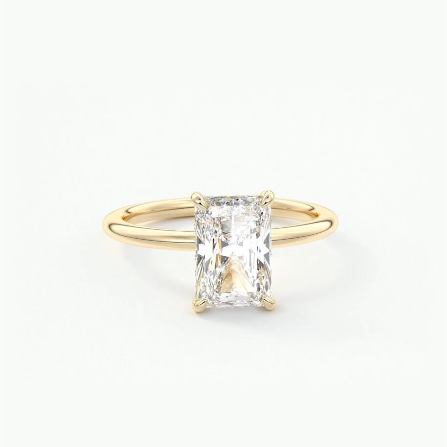 A radiant cut, solitaire engagement ring in yellow gold 