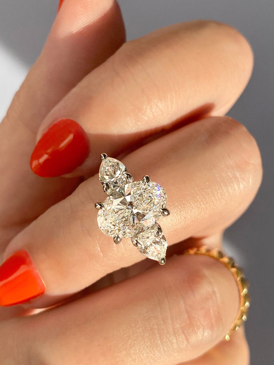 Frank Darling custom oval diamond three stone with pear side stones