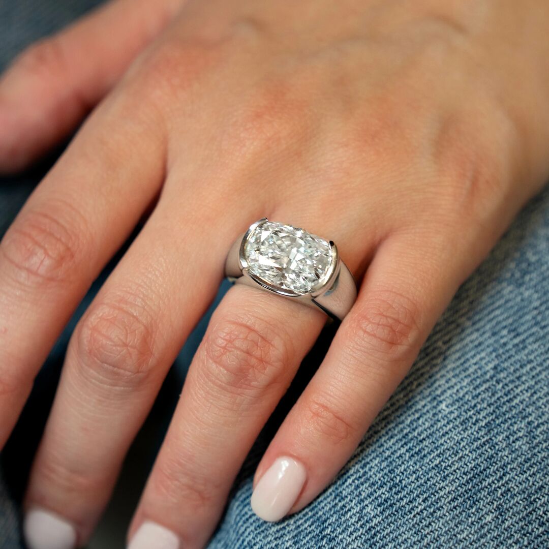 A chunky platinum engagement ring with large elongated cushion cut diamond 