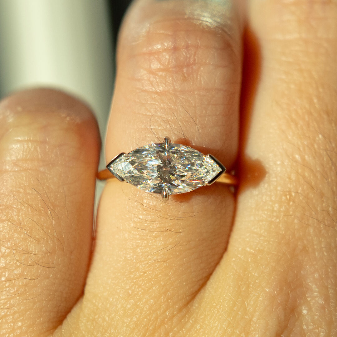 An east west set Marquise diamond with half-bezel setting 