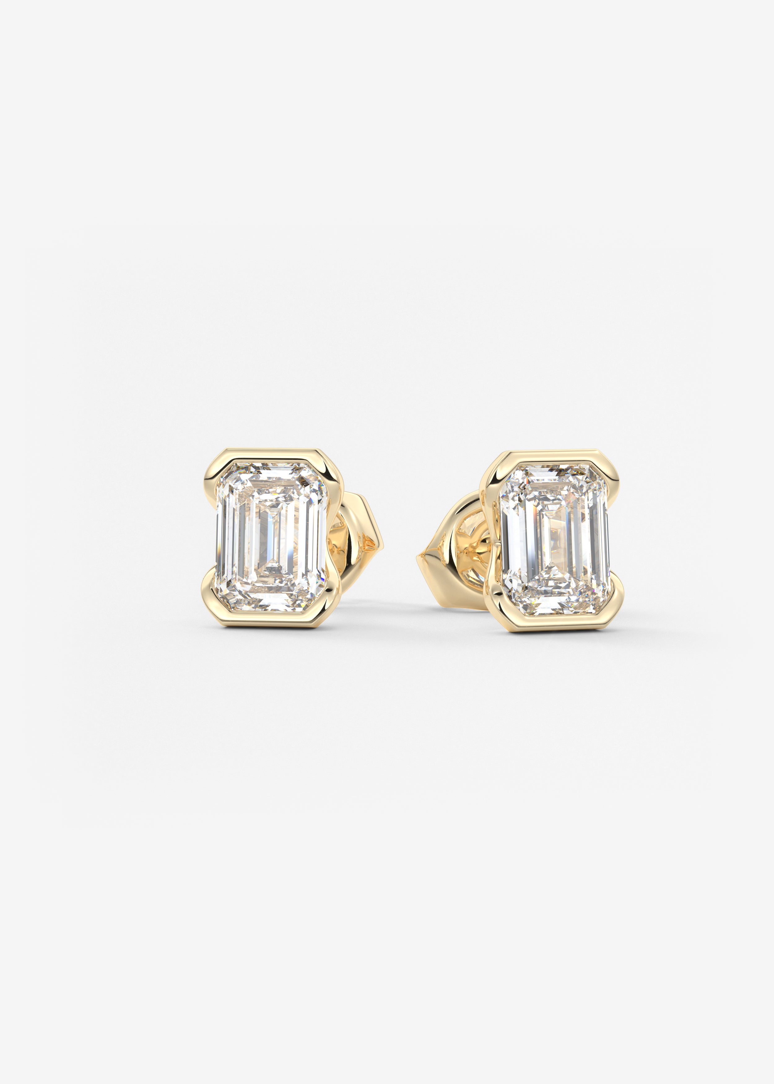 The Clutch  stud in YG metal featuring Emerald cut with Half Bezel setting